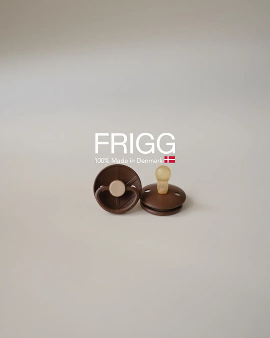 Two FRIGG Little Viking - Bjorn pacifiers with latex nipple on neutral background, with text stating "100% Made in Denmark".