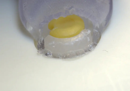 Evidence of pacifier damage caused by teething - close-up of bite marks on the silicone shield, indicating child chewing behavior.